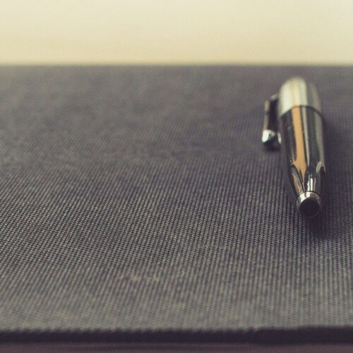 grey notebook pen